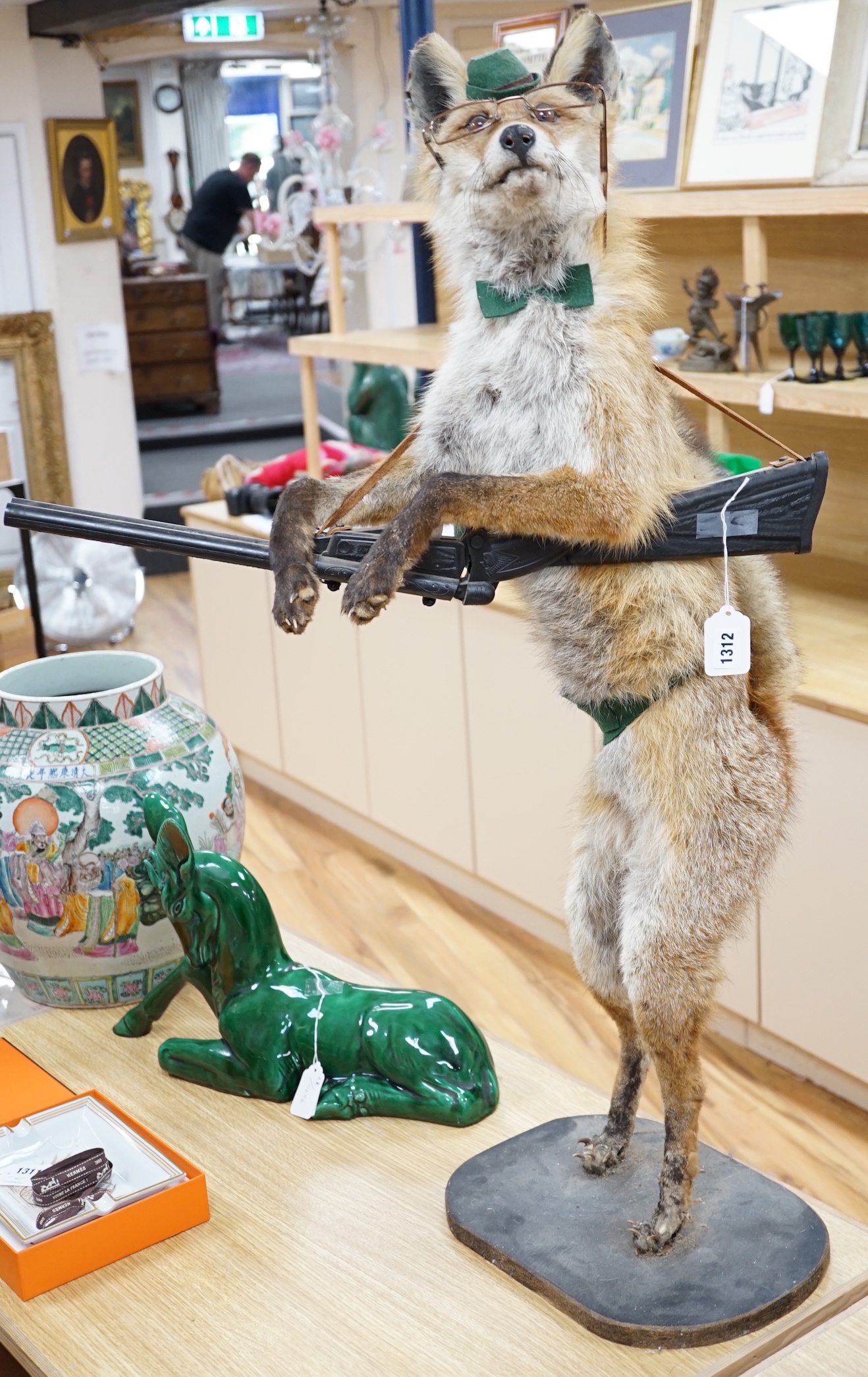 A novelty taxidermy fox group, 100cm high